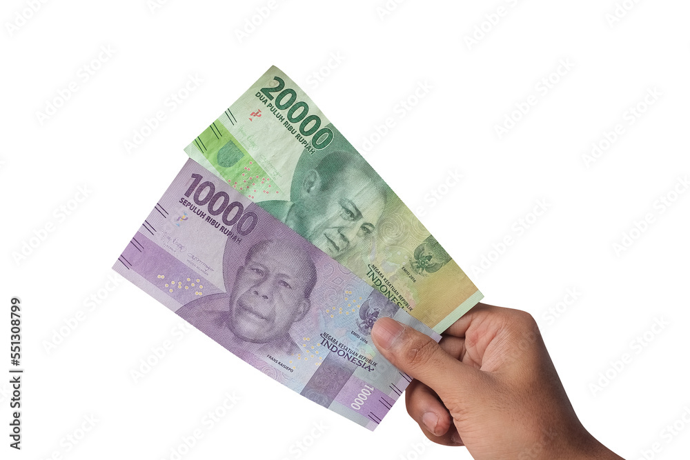 hand showing 10,000 and 20,000 rupiah isolated on white background hand showing 10,000 and 20,000 rupiah isolated on white background