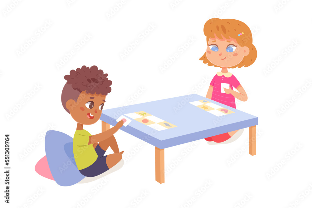 Kids play board game, boy and girl players sitting at table, playing game cards together