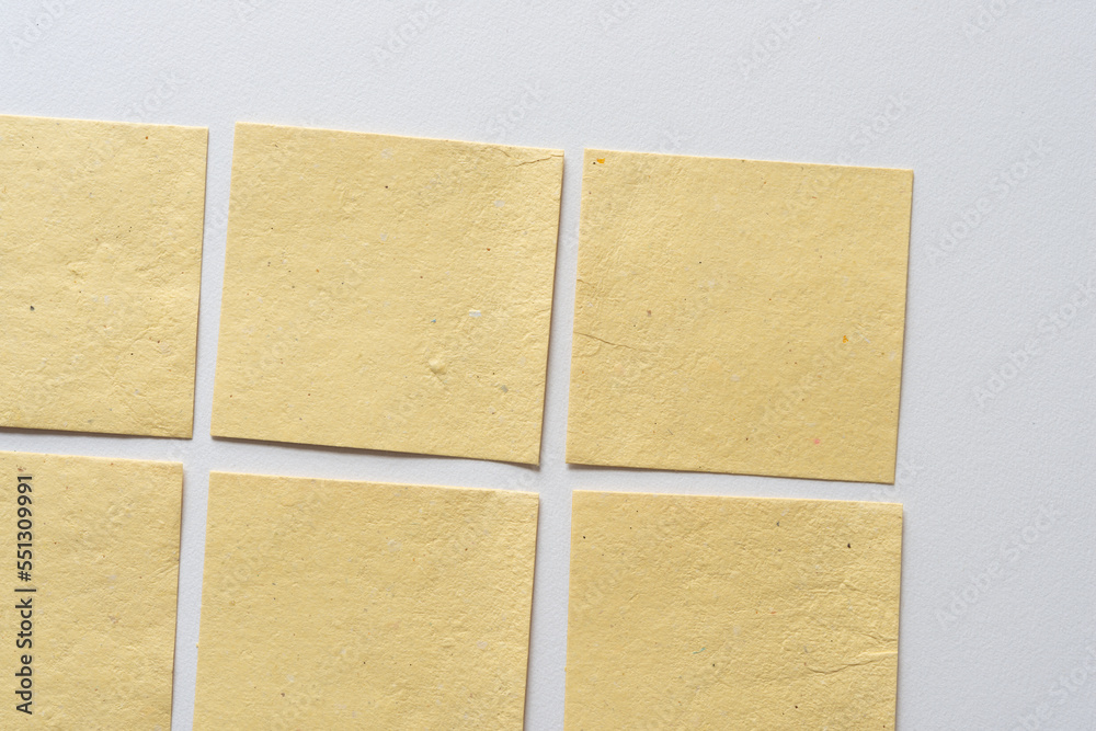 Fototapeta premium yellow paper tiles on blank paper