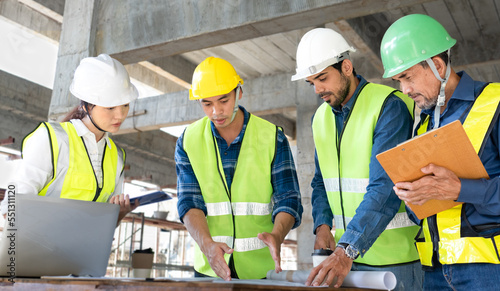 team of civil engineer manager  maintenance supervisor  professional technician foreman together with safety operator inspect and discuss the infrastructure of building construction progress at site