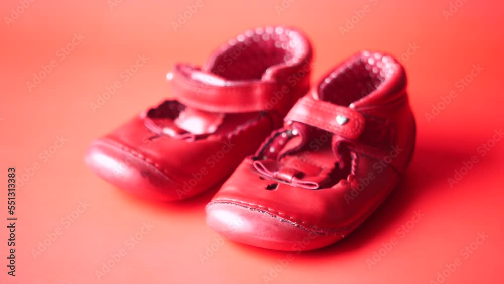 children's shoes on red color background children's shoes on red color background
