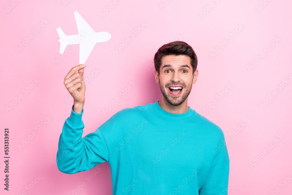 Photo of excited open mouth surprised brunet hair hold paper airplane flying passenger enjoy his trip adventures isolated on pink color background Photo of excited open mouth surprised brunet hair hold paper airplane flying passenger enjoy his trip adventures isolated on pink color background