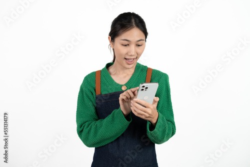 Asian waitress holding the phone with a surprised face isolated on white background.