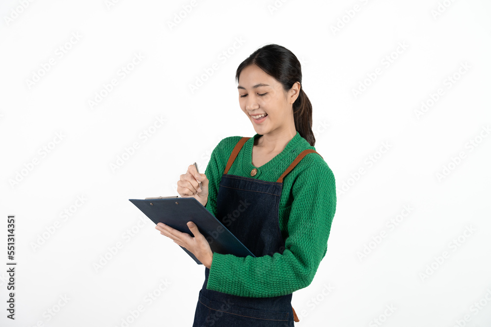 Portrait of smiling mature woman in apron holding clipboard. Beautiful waitress isolated on white background with copy space. Successful small business owner standing on white background. Portrait of smiling mature woman in apron holding clipboard. Beautiful waitress isolated on white background with copy space. Successful small business owner standing on white background.