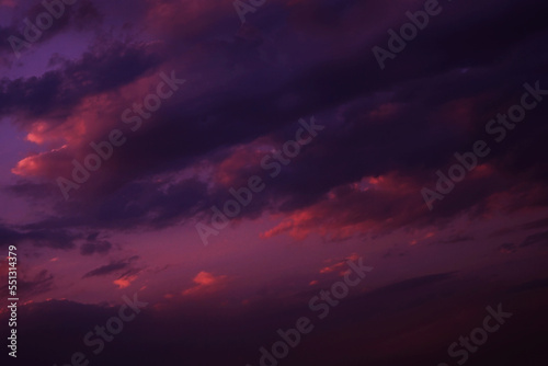 Deep purple magenta violet navy blue sky. Dramatic evening sky with clouds. Colorful sunset background for design. Dark shades. Cloudy weather. Storm. Fantasy fantastic.