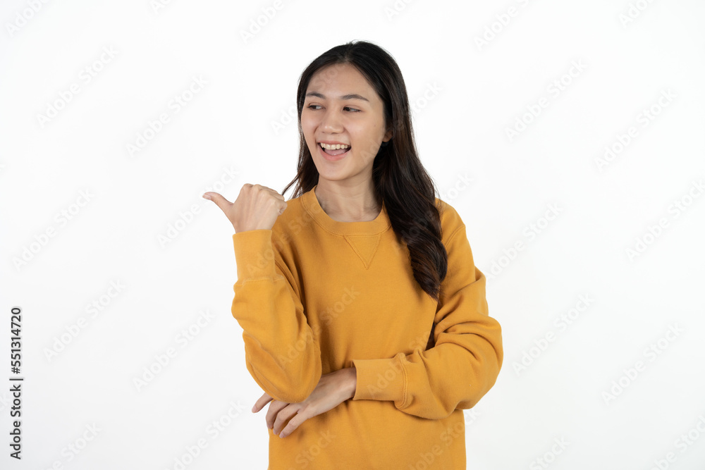Young beautiful Asian businesswoman smiling and pointing to empty copy space isolated on white background. Young beautiful Asian businesswoman smiling and pointing to empty copy space isolated on white background.