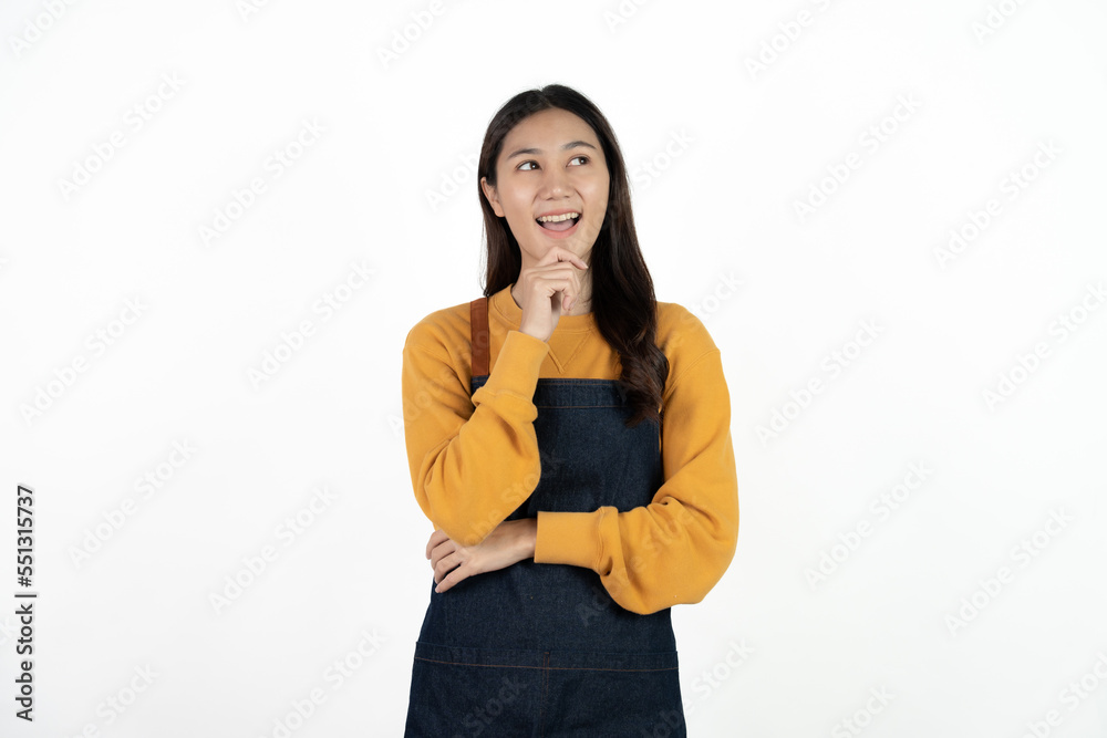 Young beautiful woman with apron standing on isolated white background pointing finger to blank space. Young beautiful woman with apron standing on isolated white background pointing finger to blank space.