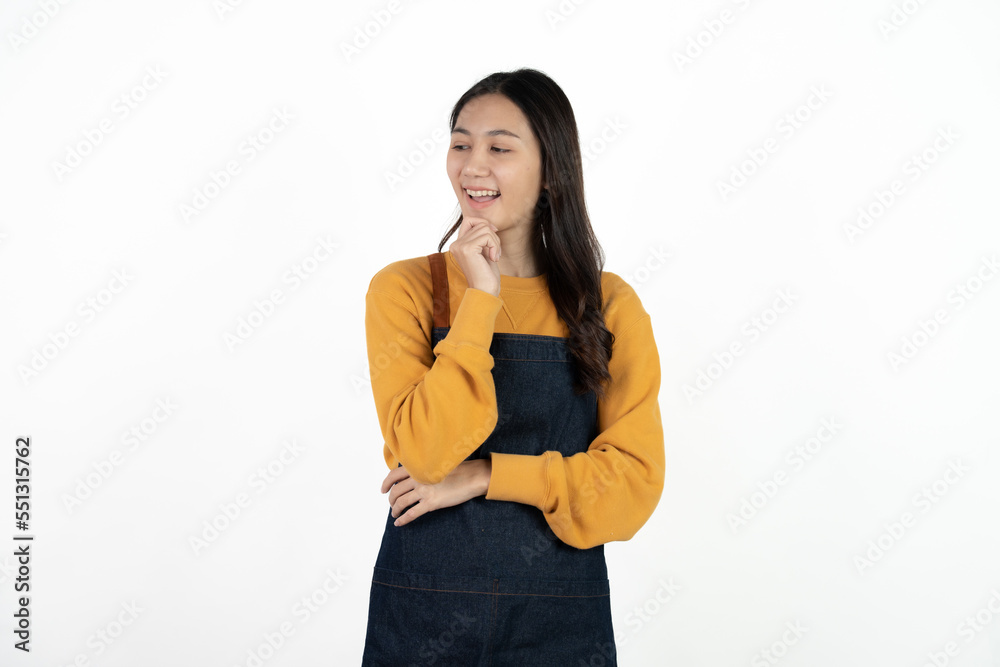 Young beautiful woman with apron standing on isolated white background pointing finger to blank space. Young beautiful woman with apron standing on isolated white background pointing finger to blank space.