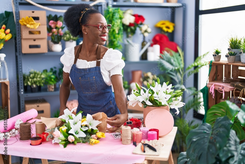 African american woman florist make bouquet of flowers at florist store