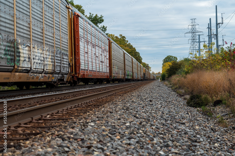 Obraz premium Freight train travelling through rural area in the midwest