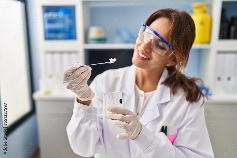 Young latin woman wearing scientist uniform working at laboratory Young latin woman wearing scientist uniform working at laboratory