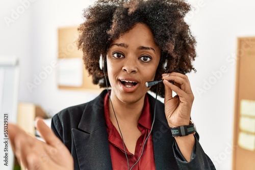 Young african american woman call center agent working at office