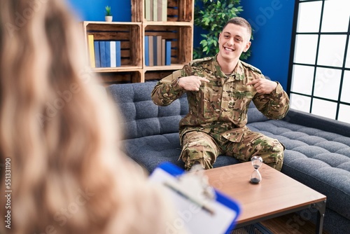 Young man doing therapy after war looking confident with smile on face, pointing oneself with fingers proud and happy. © Krakenimages.com