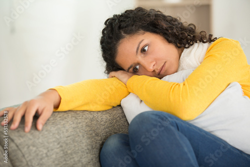 sad woman locating on comfortable couch