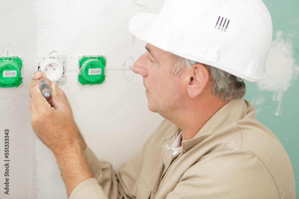 electrician installing socket in new house electrician installing socket in new house