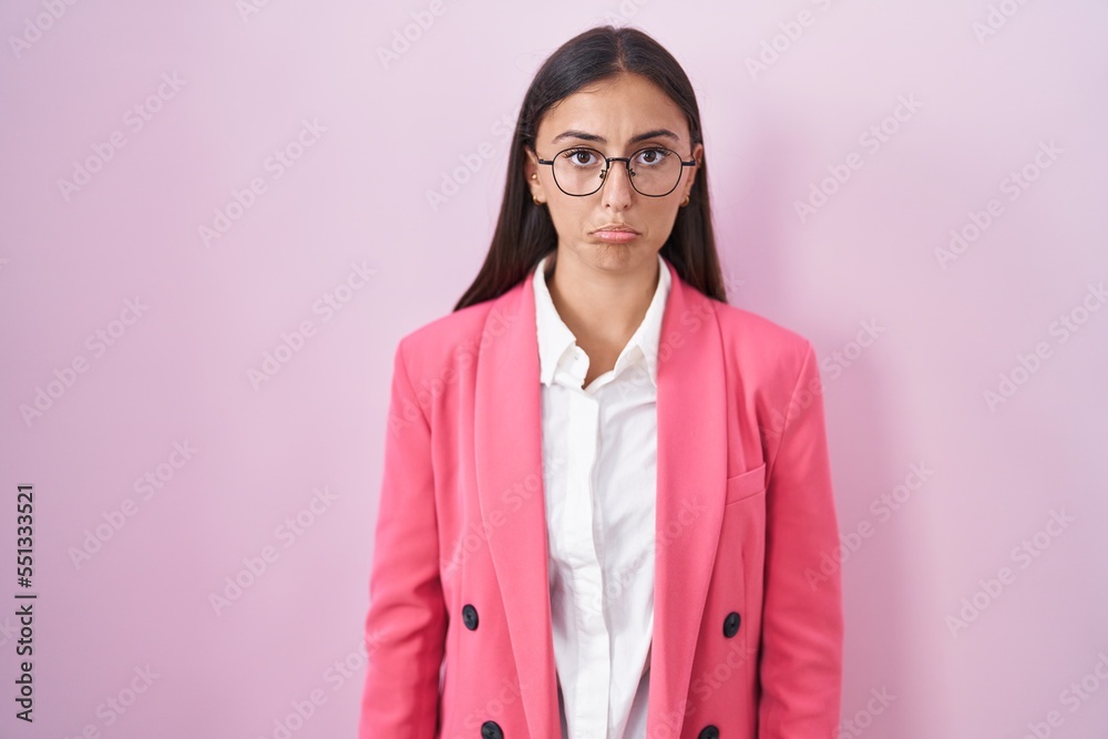 Young hispanic woman wearing business clothes and glasses depressed and worry for distress, crying angry and afraid. sad expression. Young hispanic woman wearing business clothes and glasses depressed and worry for distress, crying angry and afraid. sad expression.
