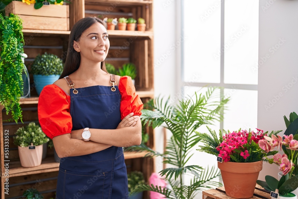 Young beautiful hispanic woman florist smiling confident standing with arms crossed gesture at florist