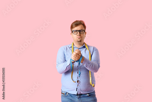 Upset young overweight man ...