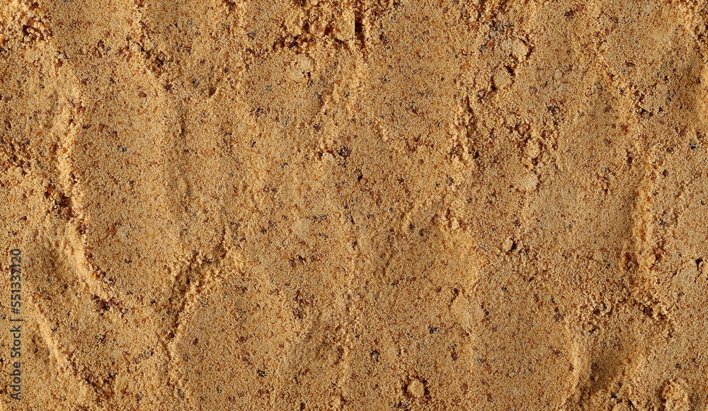 Unrefined brown cane sugar pile background and texture