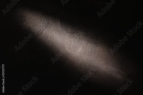 Texture of black concrete with backlight as background