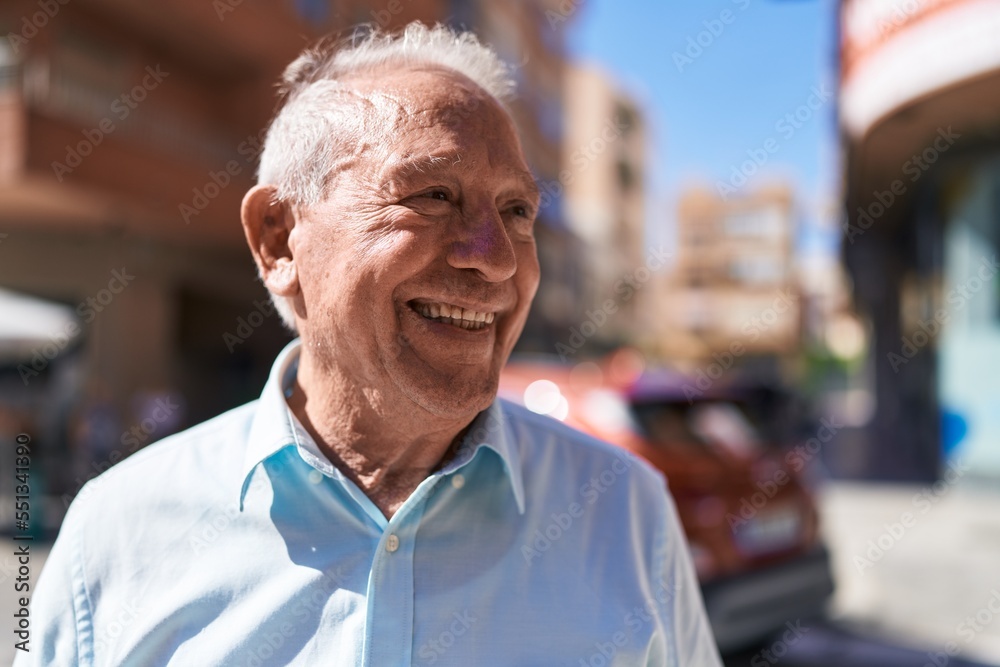 Middle age grey-haired man smiling confident looking to the side at street Middle age grey-haired man smiling confident looking to the side at street