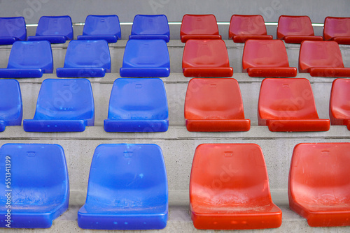 Symmetry tier of empty blue and red seats on a soccer field. Seats in the colors of Barça in horizontal. photo