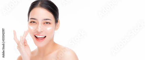 Close up Beauty portrait beautiful Asian young woman laughing applying face cream and looking camera with smile face isolated on white background Beautiful girl touching beauty facial skin on cheek