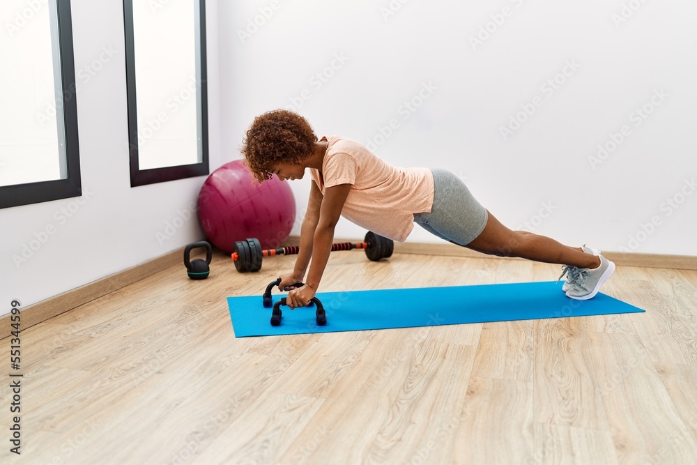 Young african american woman smiling confident training push-up exercise at sport center Young african american woman smiling confident training push-up exercise at sport center