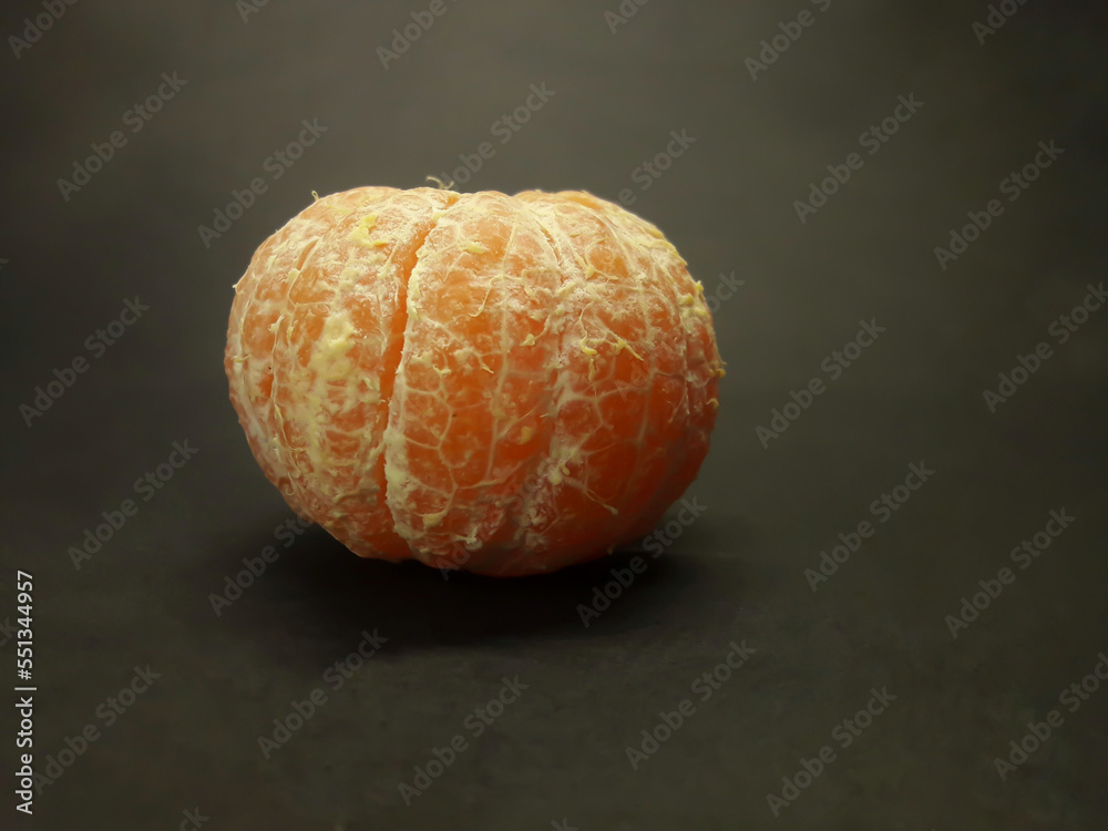 peeled citrus fruits on a black background peeled citrus fruits on a black background