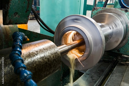 Fototapeta Internal grinding of a cylindrical mandrel with a water-cooled abrasive stone on a grinding machine.