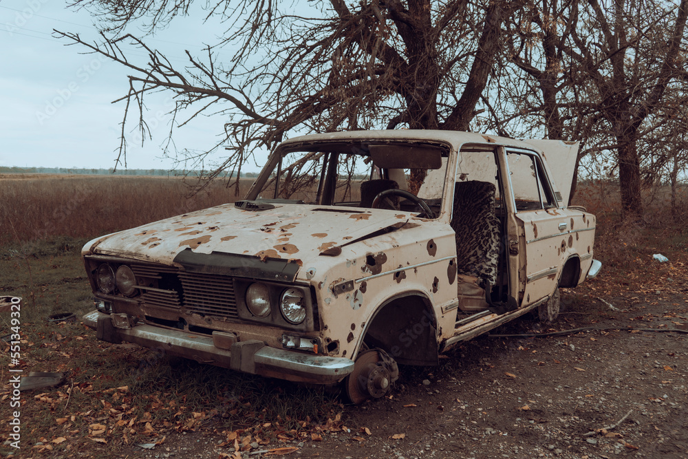 Countryside. Damaged civilian car stands on the side of the road