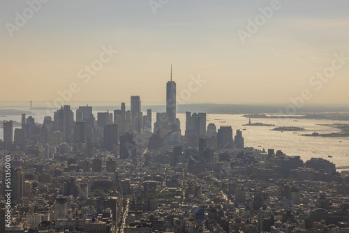 Beautiful view of skyscrapers of densely built-up Manhattan against smoke sky. New York. USA. 
