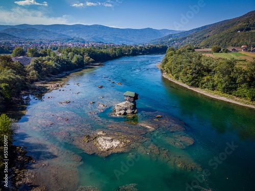 Aerial shot of a house in the middle of River Drina in Perucac, Bajina Basta, Serbia photo