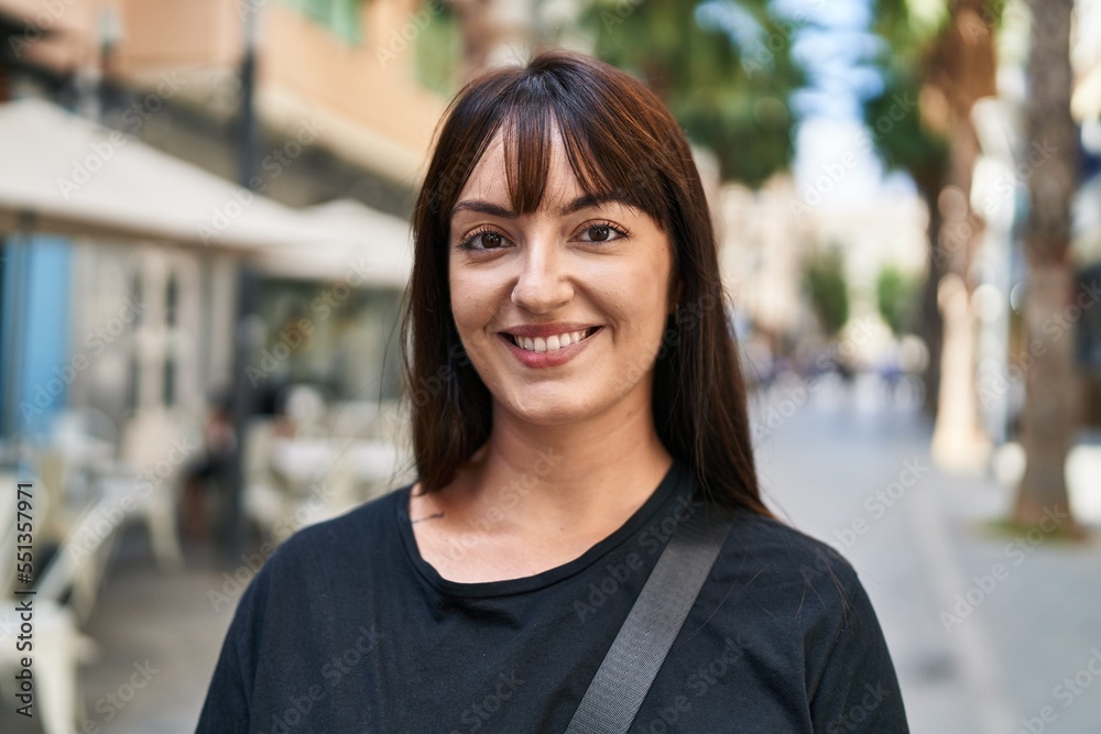 Young beautiful hispanic woman smiling confident standing at coffee shop terrace Young beautiful hispanic woman smiling confident standing at coffee shop terrace