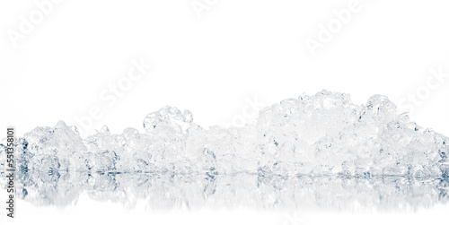 Natural crystal clear heap of crushed ice, melting ice cubes on the white reflective surface background.