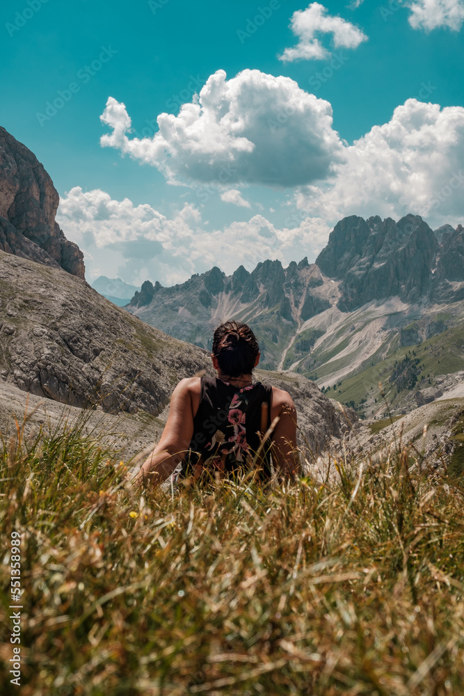 Hiker enjoying an amazing panorama of the Dolomites. Summer road trip in Trentino Alto Adige, Italy