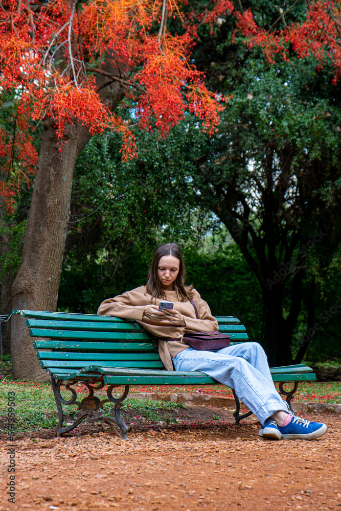 a young girl in the park sitting under a tree a young girl in the park sitting under a tree