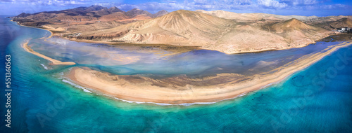 Aerial drone view of famous Sotavento beach lagoon and sandbar, Fuerteventura, Canary islands. Scenic summer background of turquoise ocean water. Hot spot for wind and kitesurfing. Space for text