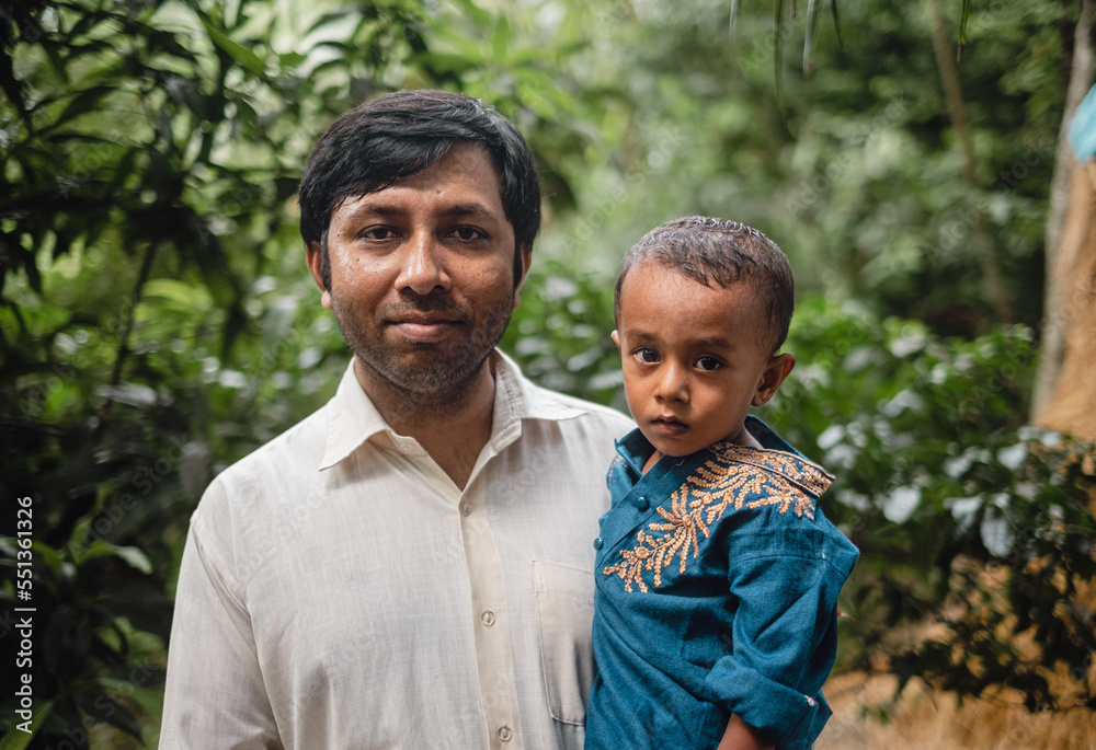 South asian young father holding his little son South asian young father holding his little son