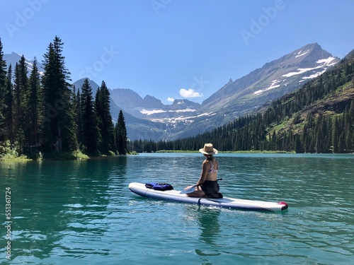 Woman paddle boarding on lake 