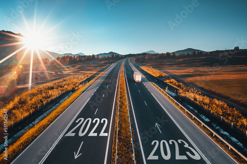 2023 Happy New Year text on the road, concept for trip travel and future vision for successful start straight, planning and challenge or career path,business strategy,opportunity and change, new goals photo