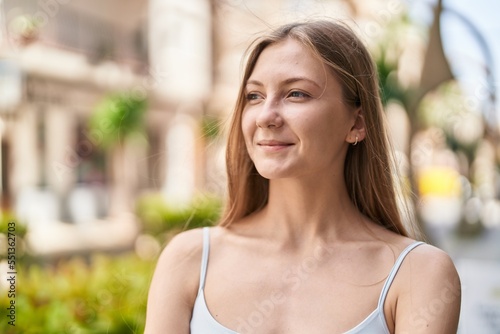 Young caucasian woman smiling confident looking to the side at street