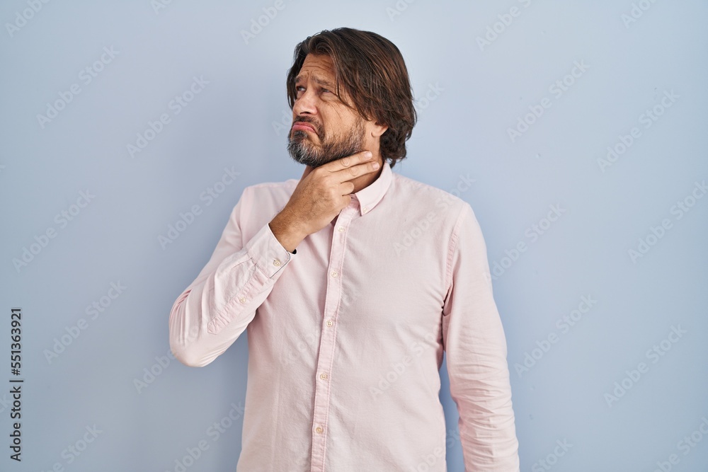 Handsome middle age man wearing elegant shirt background touching painful neck, sore throat for flu, clod and infection