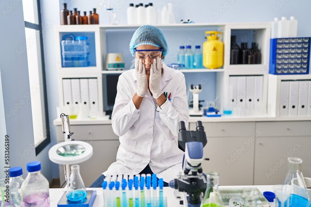 Brunette woman working at scientist laboratory rubbing eyes for fatigue and headache, sleepy and tired expression. vision problem Brunette woman working at scientist laboratory rubbing eyes for fatigue and headache, sleepy and tired expression. vision problem