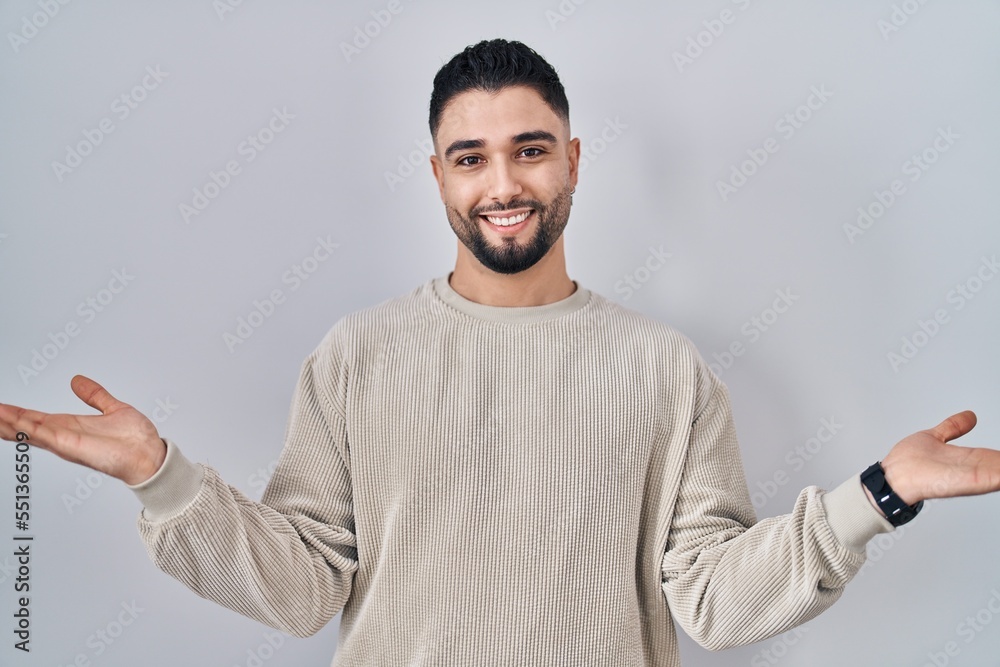 Young handsome man standing over isolated background smiling cheerful offering hands giving assistance and acceptance. Young handsome man standing over isolated background smiling cheerful offering hands giving assistance and acceptance.
