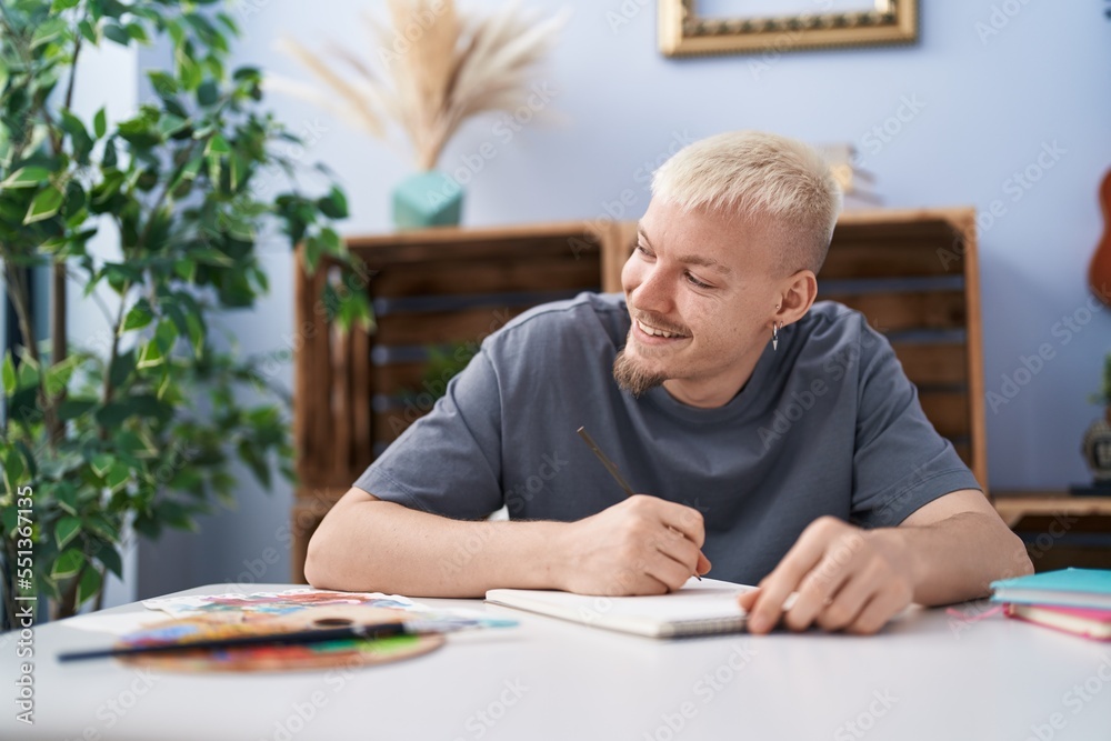 Young caucasian man smiling confident drawing on notebook at home Young caucasian man smiling confident drawing on notebook at home