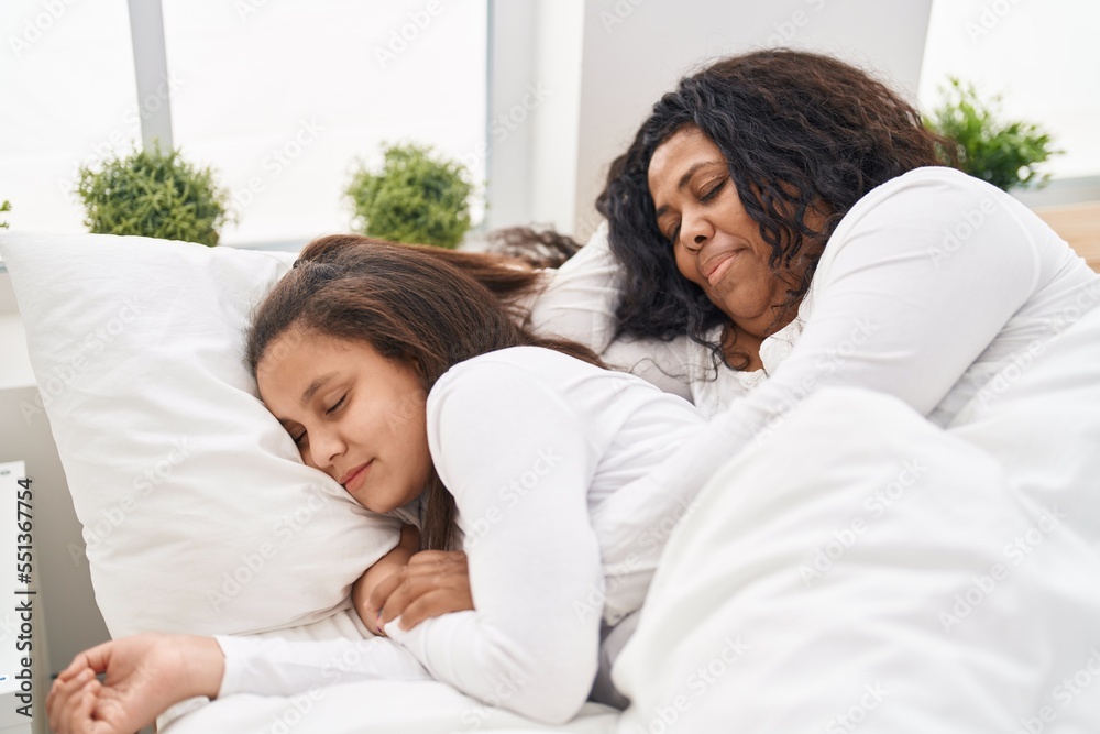 Obraz premium Mother and daughter lying on bed sleeping at bedroom