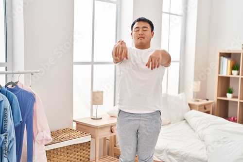 Canvas Print Young chinese man somnambulist sleepwalking at bedroom
