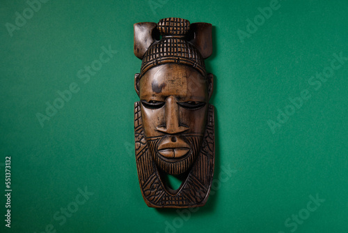 Old African mask on green green