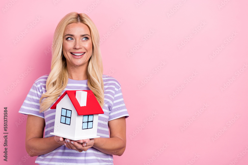 Photo of lovely adorable lady hold little house look empty space dream own real estate isolated on pink color background Photo of lovely adorable lady hold little house look empty space dream own real estate isolated on pink color background